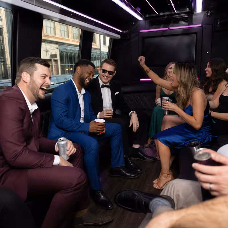 Party bus interior with wraparound leather seating and LED lighting in Baton Rouge