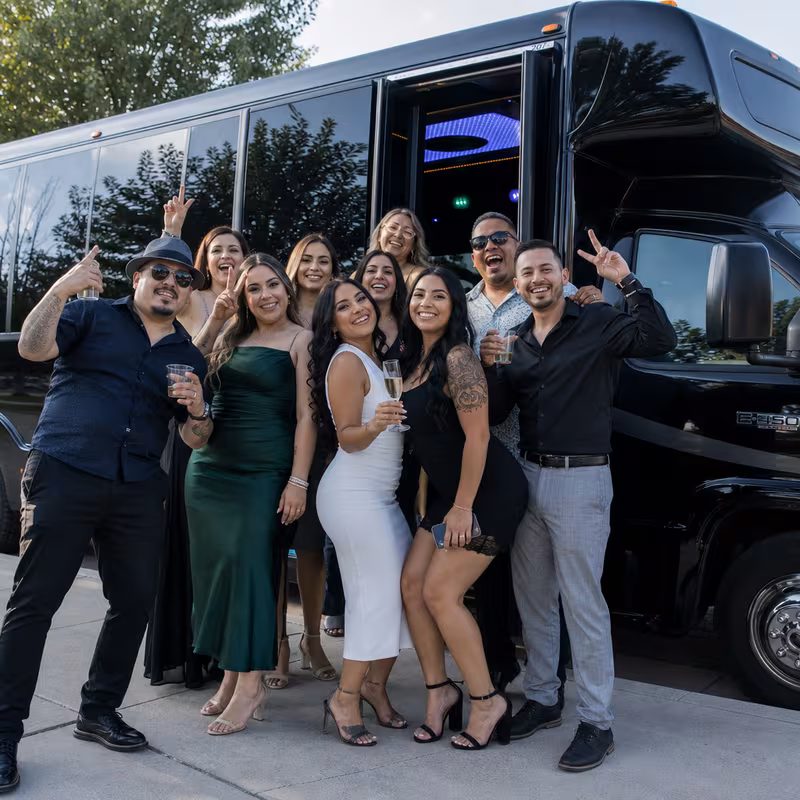 Group boarding a white charter bus for Birthday Transportation transportation in Baton Rouge