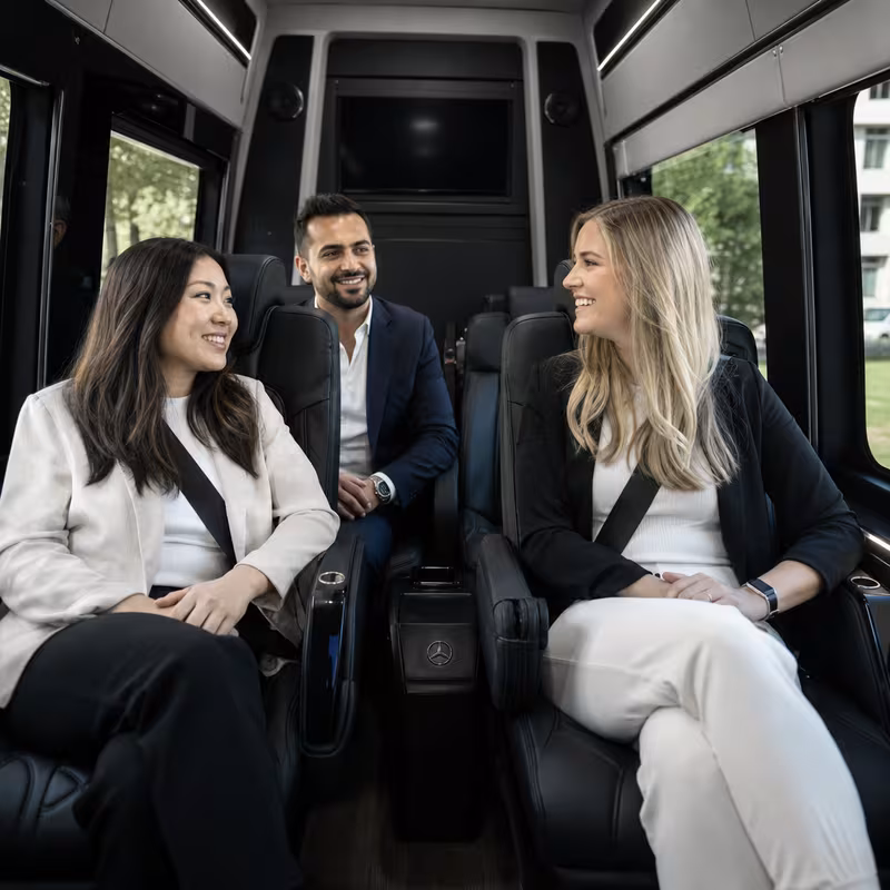 Group boarding a white charter bus for Corporate Transportation transportation in Baton Rouge