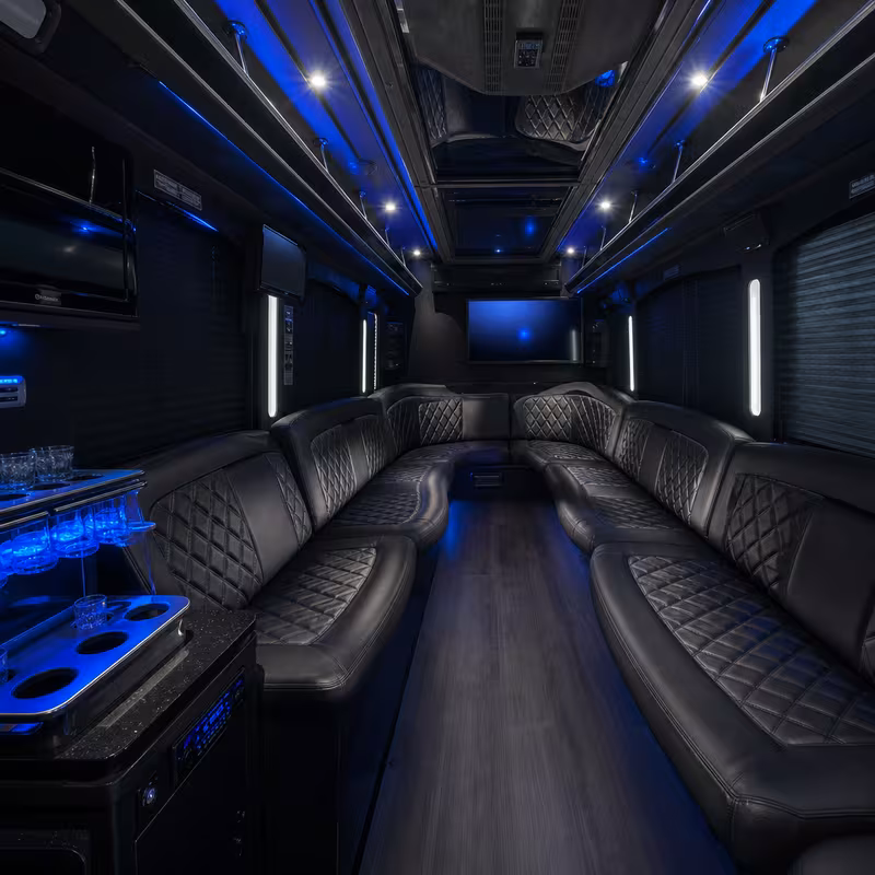 Party bus interior with wraparound leather seating and LED lighting in Baton Rouge
