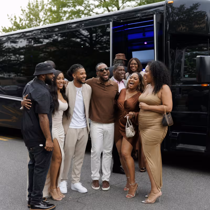Passengers loading luggage while boarding an Baton Rouge group shuttle