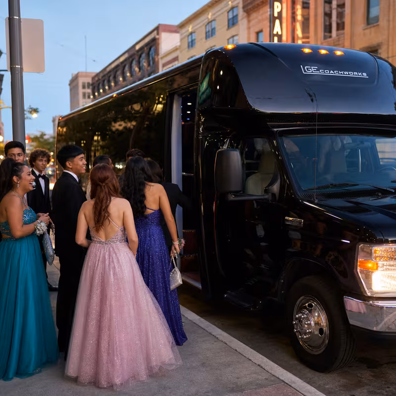 Passengers loading luggage while boarding an Baton Rouge group shuttle