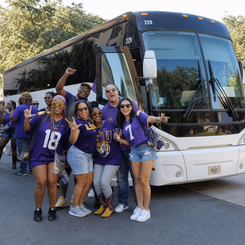 Passengers loading luggage while boarding an Baton Rouge group shuttle