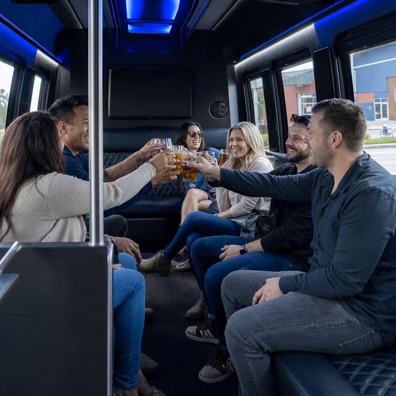 Group boarding a white charter bus for Winery & Brewery Tour Transportation transportation in Baton Rouge